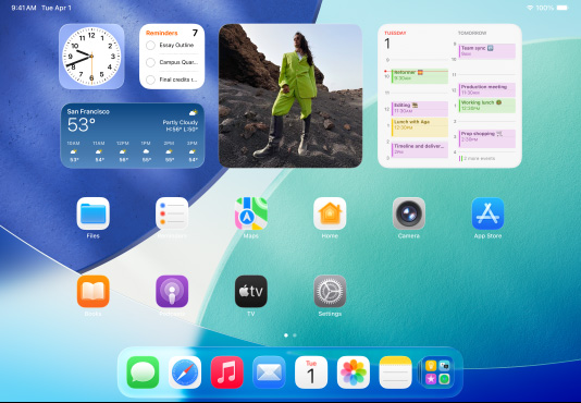三款 iPad 机型横屏放置,中间的机型位于另外两款前方,Apple Pencil 以磁力吸附在中间机型的顶部;中间屏幕显示主屏幕,展示具有 Liquid Glass 效果的彩色 app 图标;左侧屏幕展示预览 app;右侧屏幕展示主屏幕,多个文件以扇状形式从程序坞中展开。